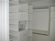 Organize and add extra storage space by custom designing a large walk-in closet with shelves & drawers